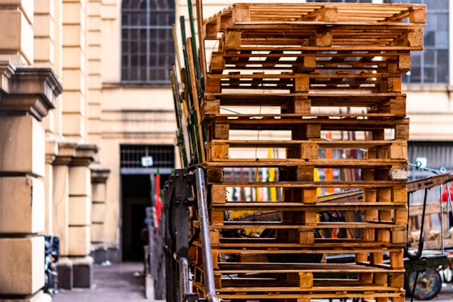 A delivery truck loaded with recycled pallets ready to be shipped across Spain on a sunny day.