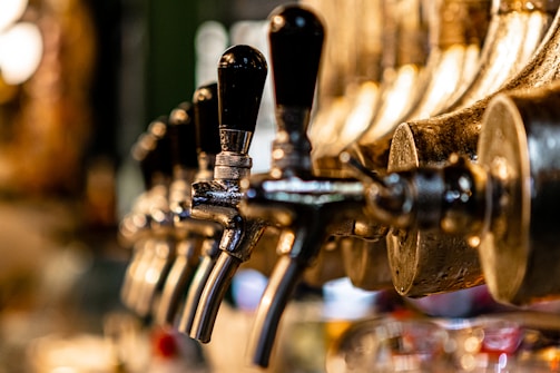 A close-up of freshly installed beer taps gleaming under soft pub lighting.