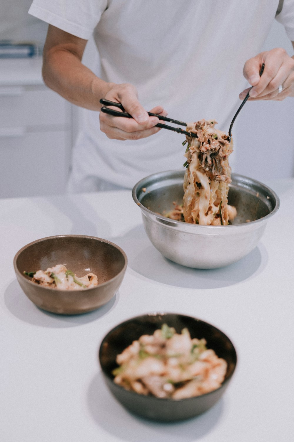 person holding stainless steel spoon and fork