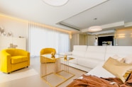 yellow sofa beside white sofa