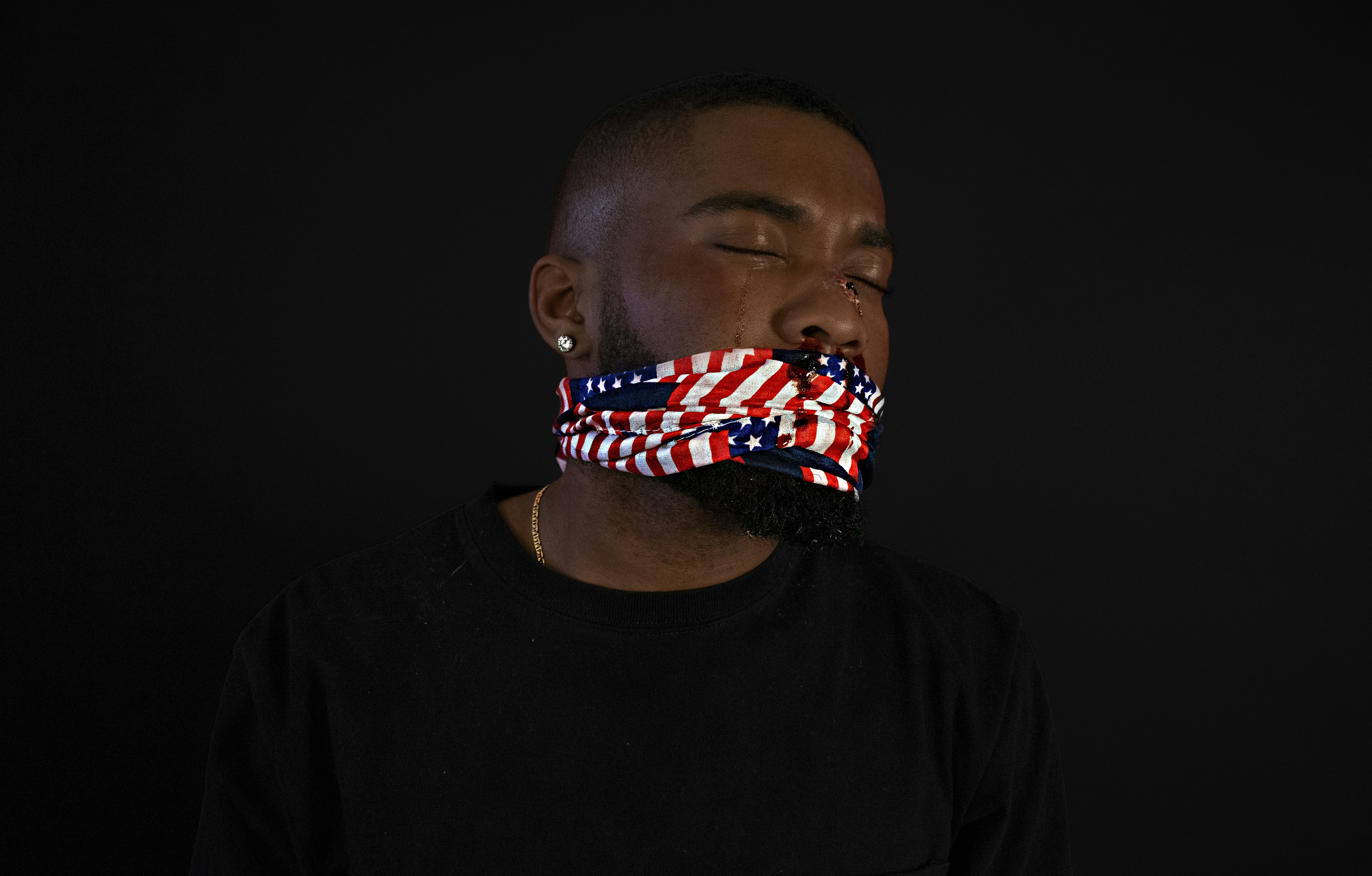 man in black crew neck shirt with us flag print on his head