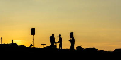A lively band performing on an outdoor stage at sunset during Sonorafest.