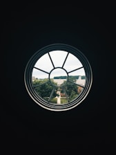 A friendly technician installing a new window in a sunny suburban home.