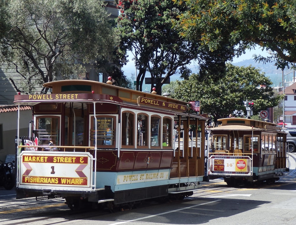 white and red tram on road during daytime