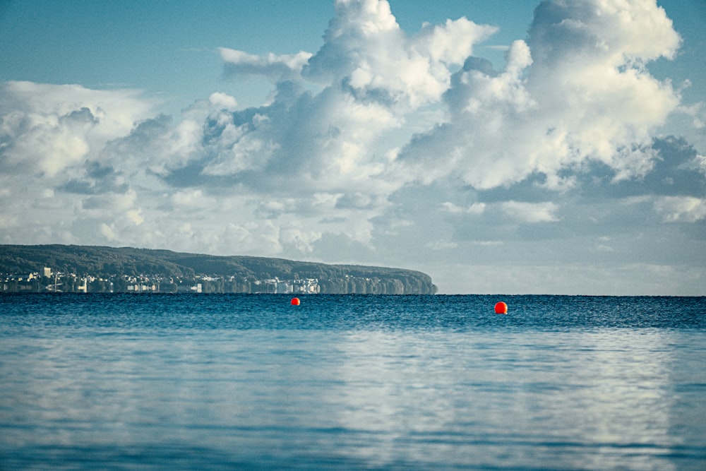 people on beach under white clouds and blue sky during daytime