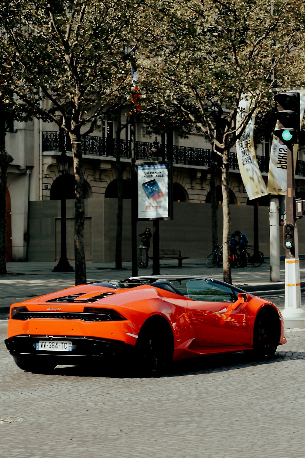 red ferrari 458 italia parked on sidewalk during daytime