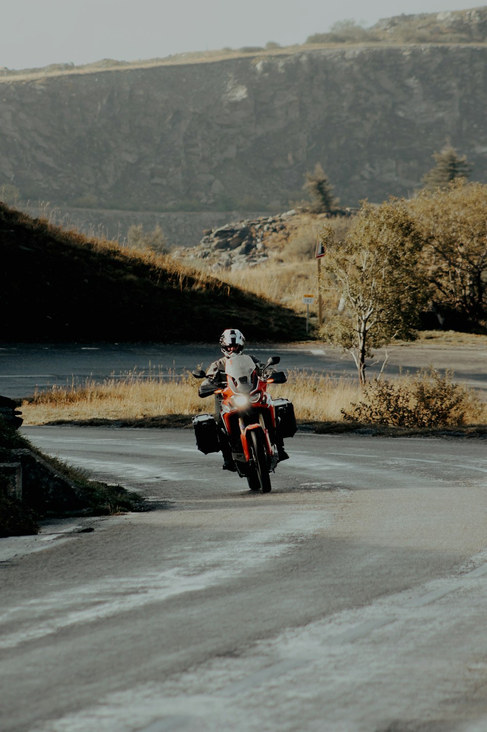man in white shirt riding motorcycle on road during daytime