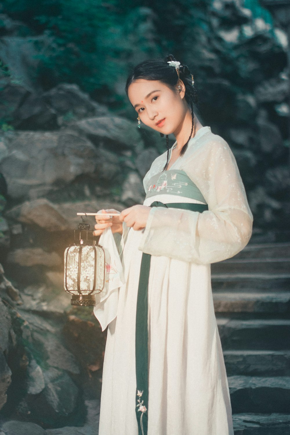 woman in white robe holding clear glass mug