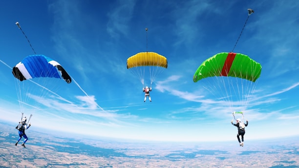 person in blue shirt and black pants riding yellow and red parachute