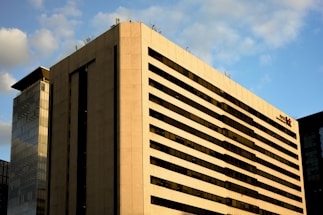 Modern office building with city skyline in the background.