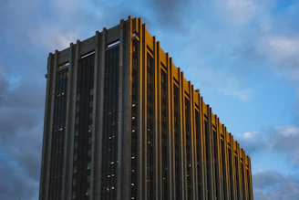 A sturdy new government office building with clean lines and navy blue accents, captured during midday