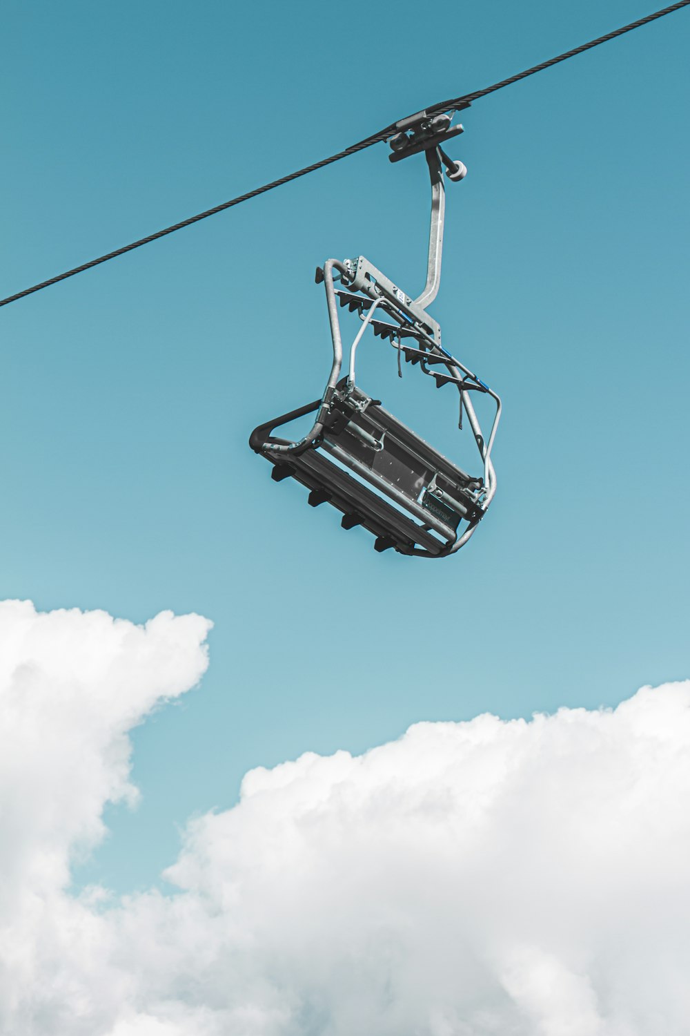 black cable car under blue sky and white clouds during daytime