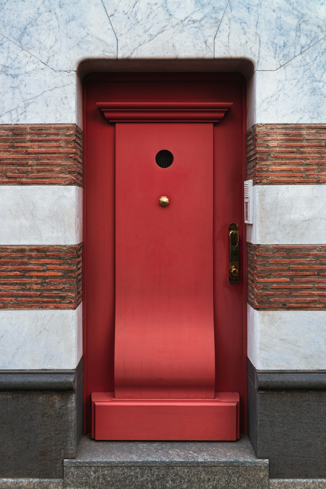 red wooden door with gold door knob