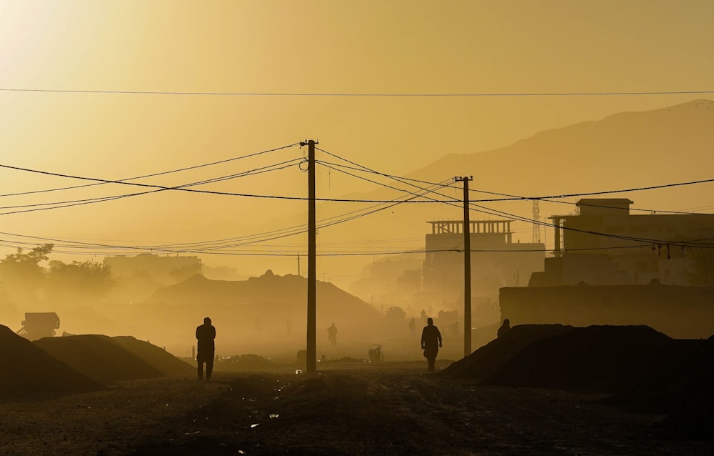 silhouette of person standing on hill during daytime, how do we rebuild Afghanistan?