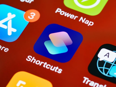 A close-up view of smartphone app icons on a screen, including Shortcuts, with bright and vibrant colors.