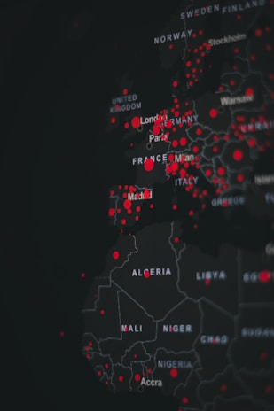 A digital map highlighting various countries in Europe and Africa with red dots indicating specific points of interest. The map is dark-themed with bright red markers concentrated around major cities.