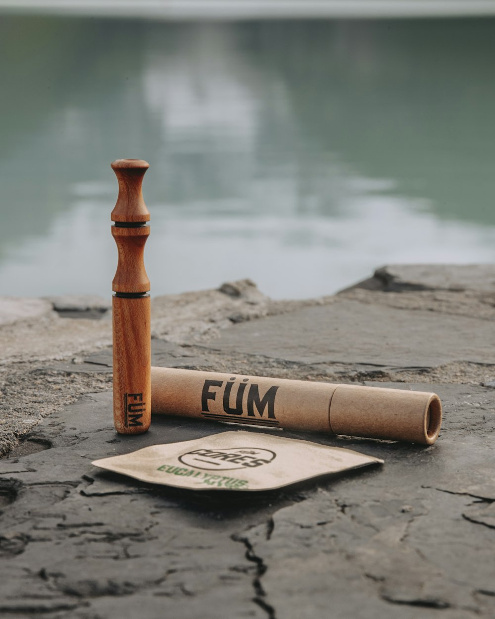 brown wooden rolling pin on gray sand