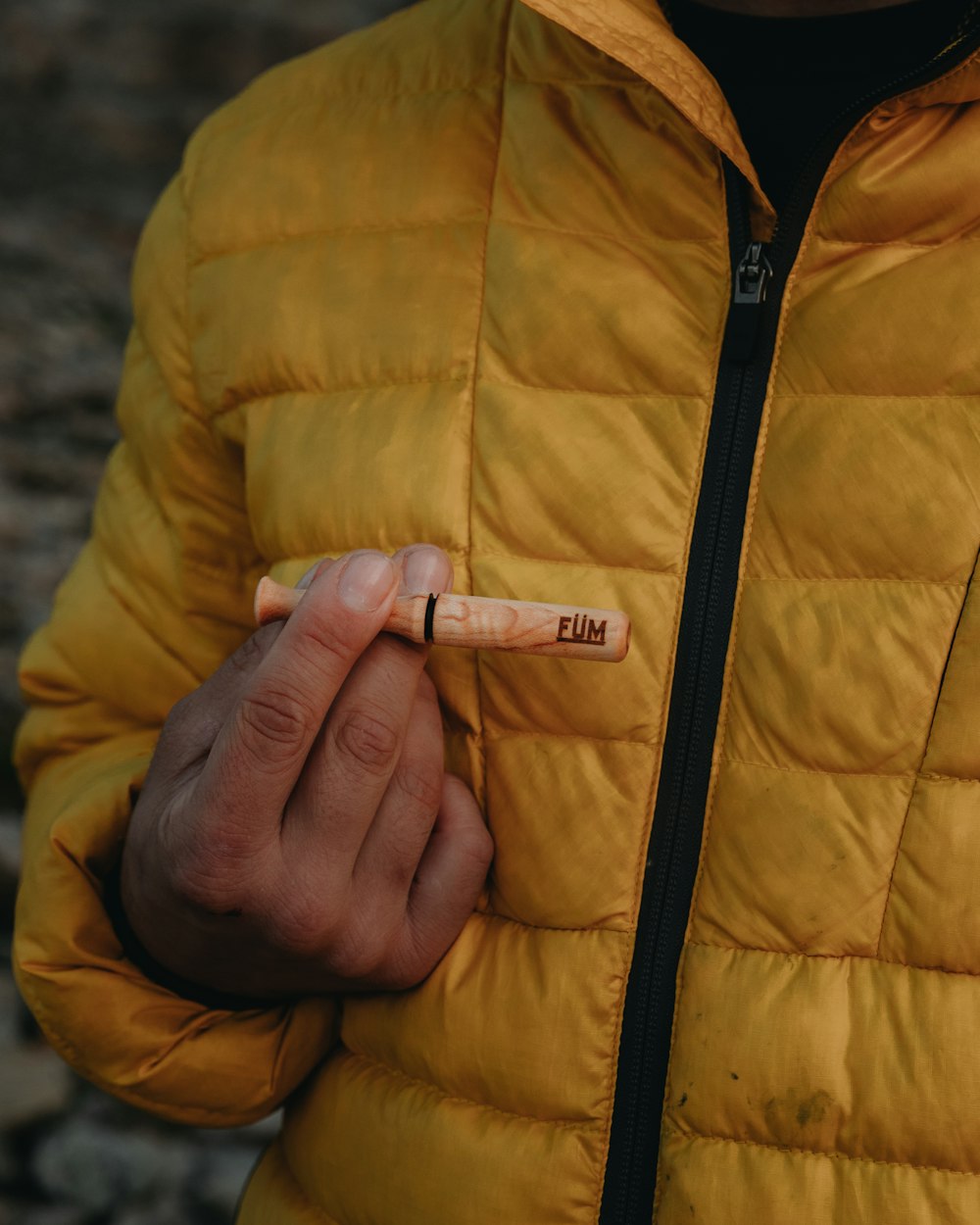 person holding white and black labeled soft tube