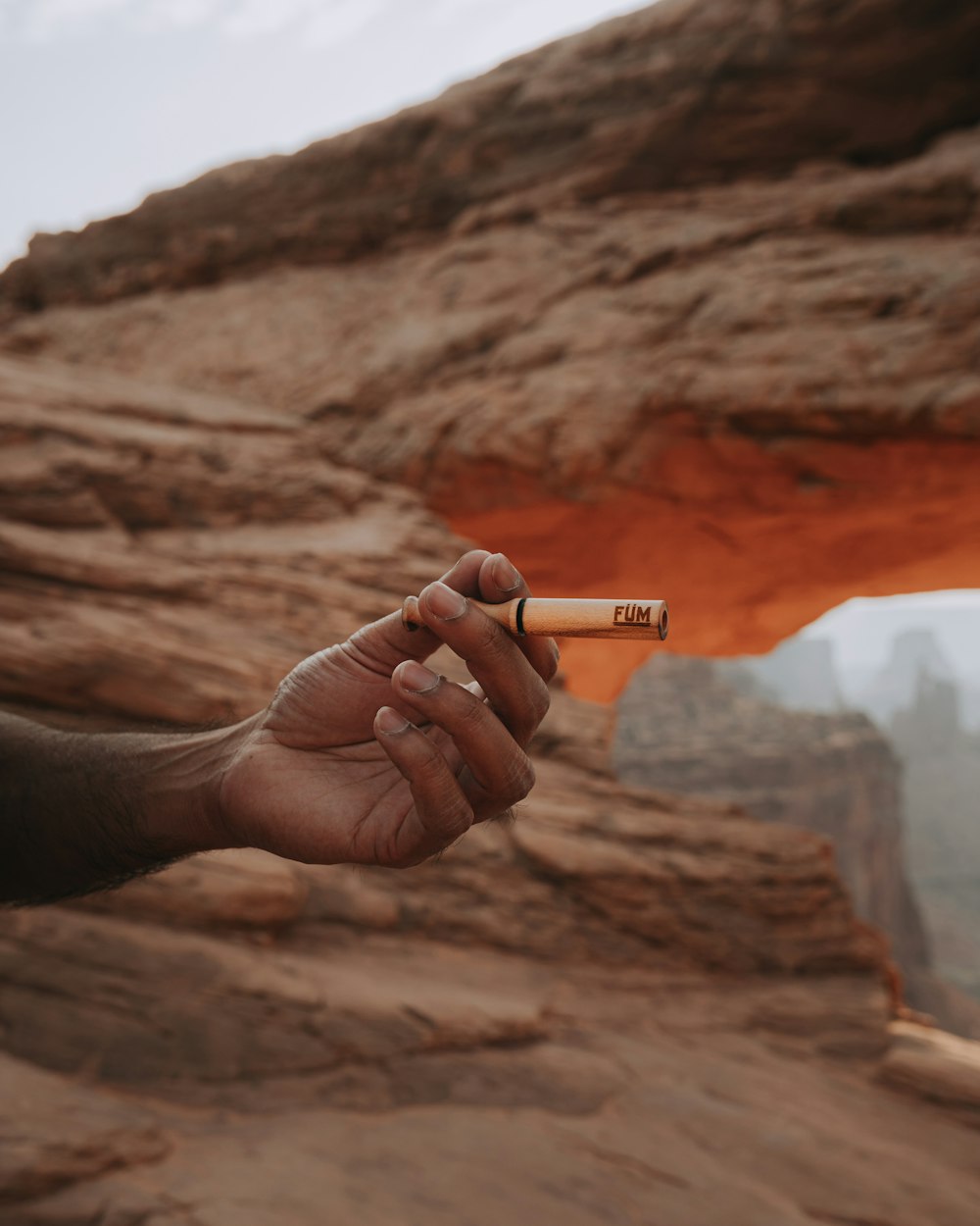 person holding white cigarette stick