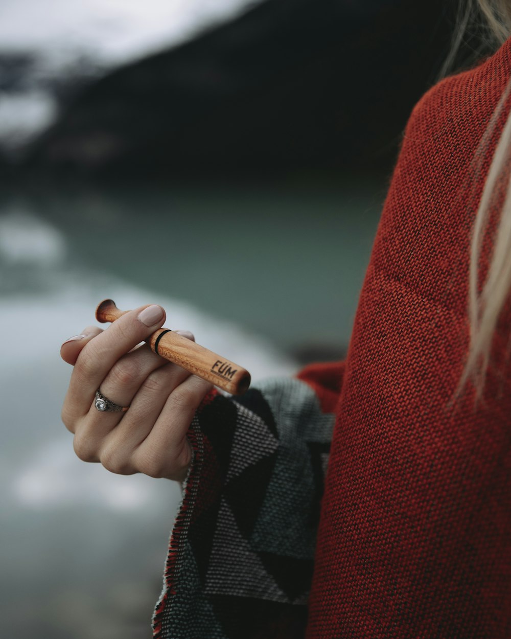 person holding orange disposable lighter