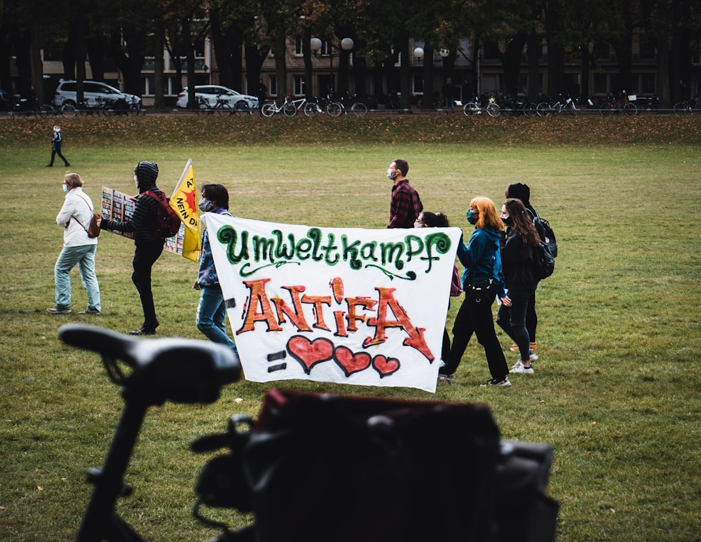 people walking on green grass field during daytime