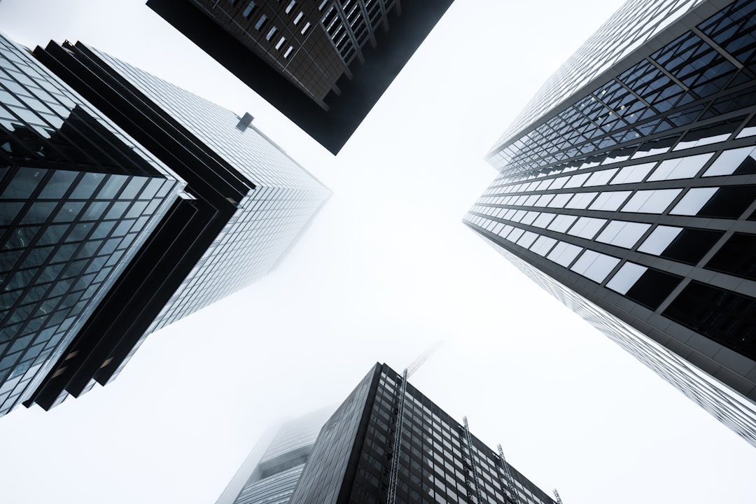 low angle photography of high rise buildings, Skyscrapers in the morning fog.