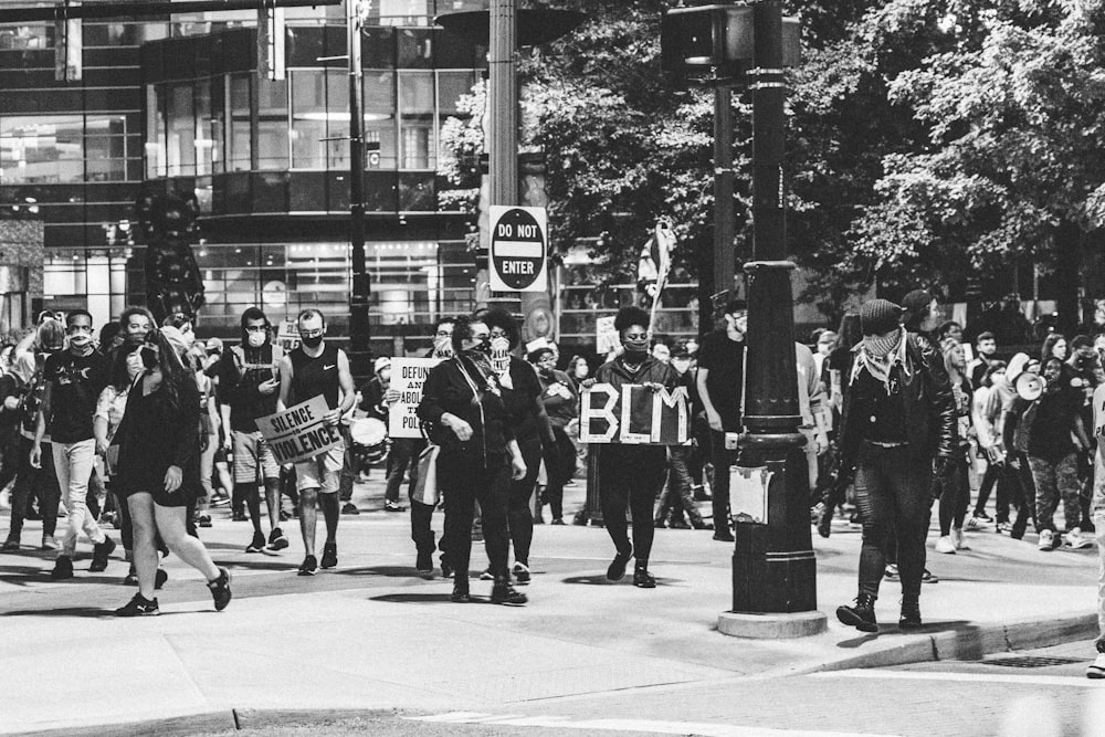 grayscale photo of people walking on street