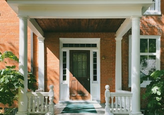 brown brick house with white wooden door