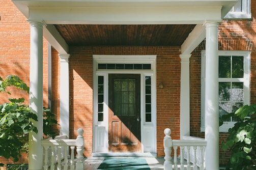 brown brick house with white wooden door