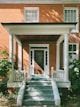 brown brick house with white wooden door