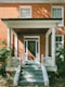 brown brick house with white wooden door