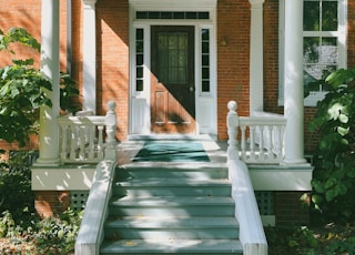 brown brick house with white wooden door