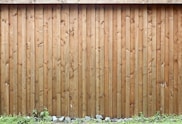brown wooden fence with white flowers