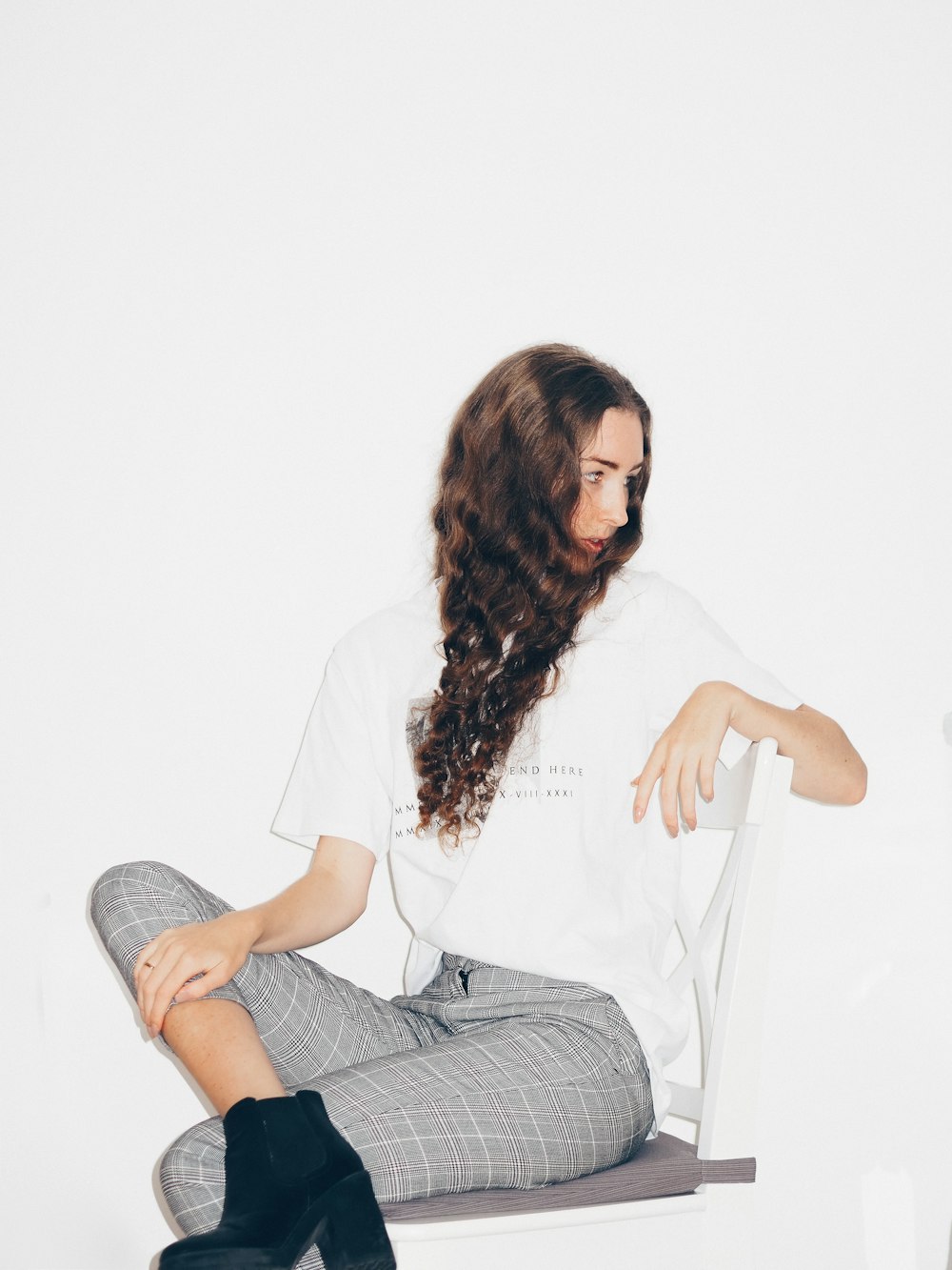 woman in white shirt sitting on white chair