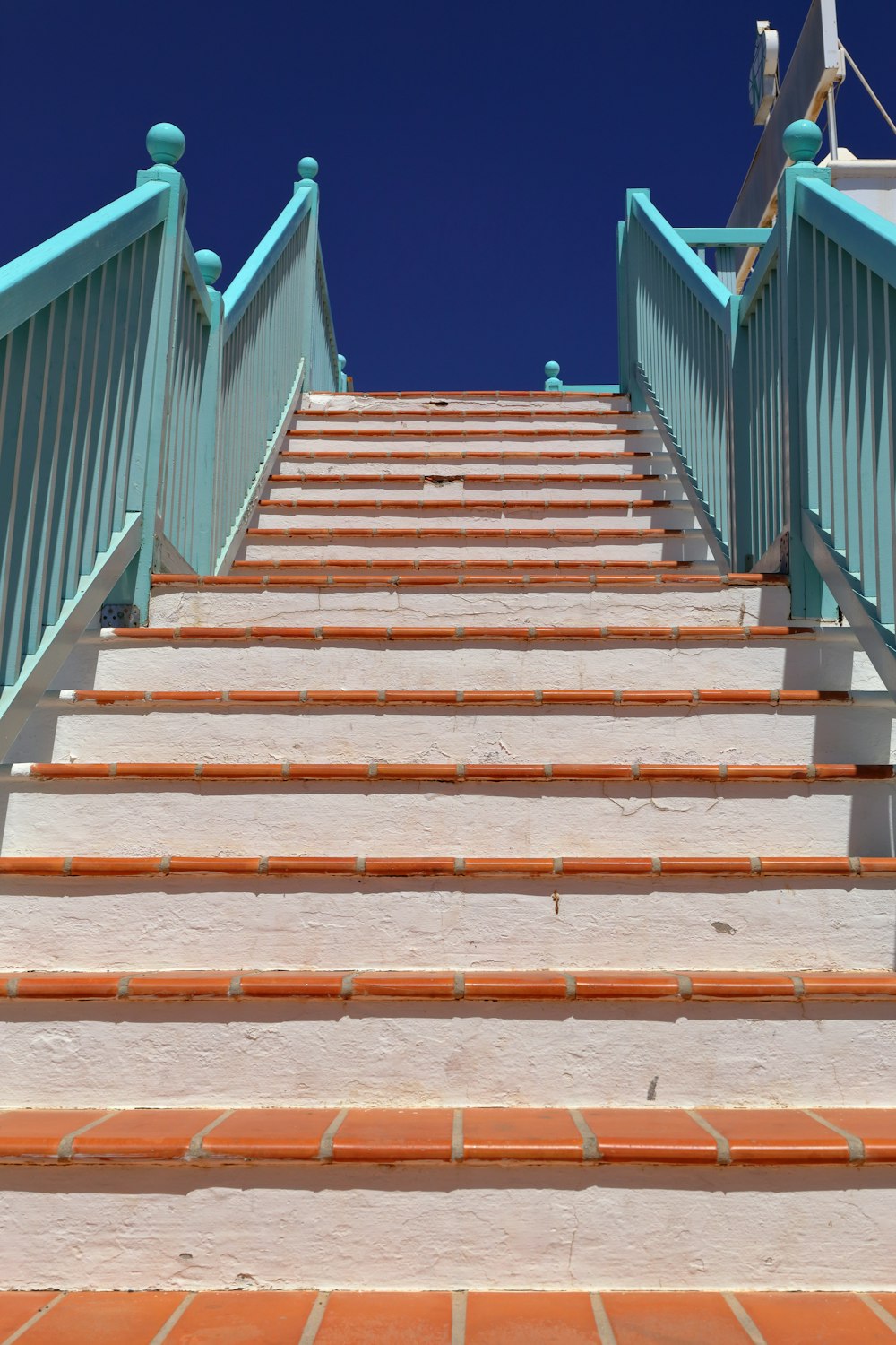 brown wooden staircase with blue railings