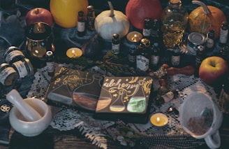 red apple fruit beside silver and gold buddha figurine