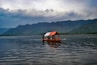 brown wooden boat on body of water during daytim