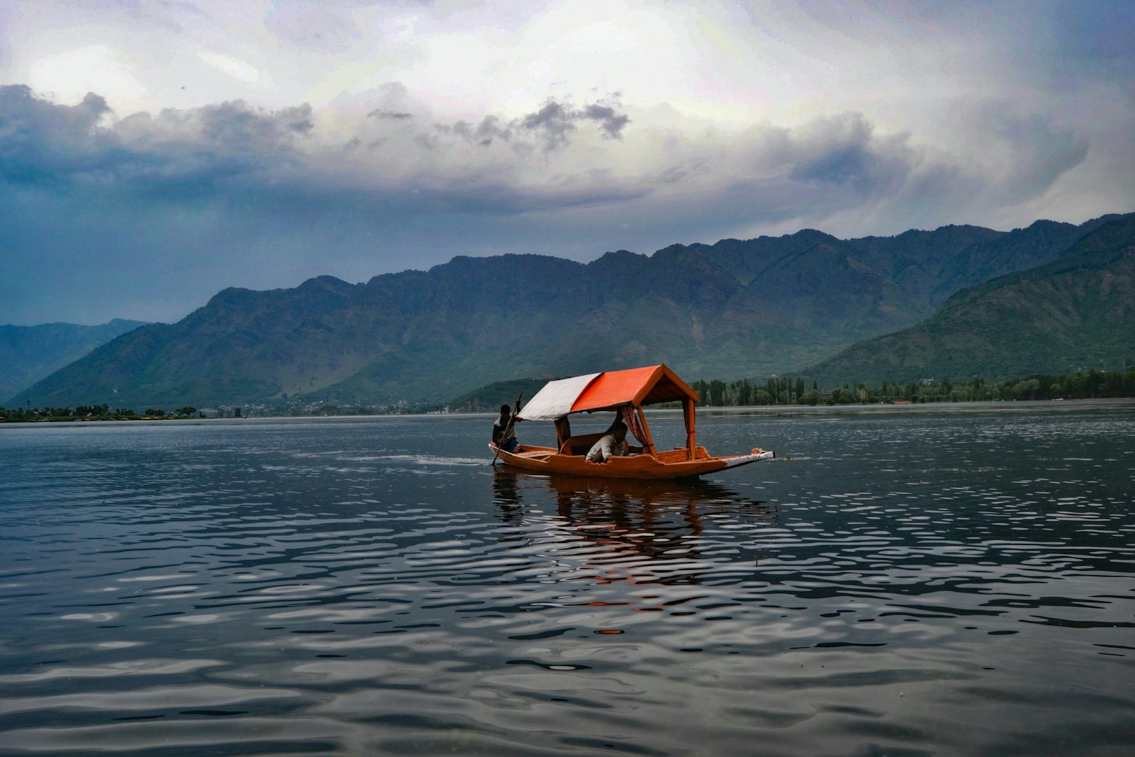 A boat on a lake in the Kashmir region (Renzo D'souza via Unsplash)