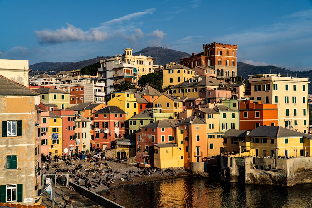 Edifici di cemento marrone e bianco accanto al fiume sotto il cielo blu durante il giorno