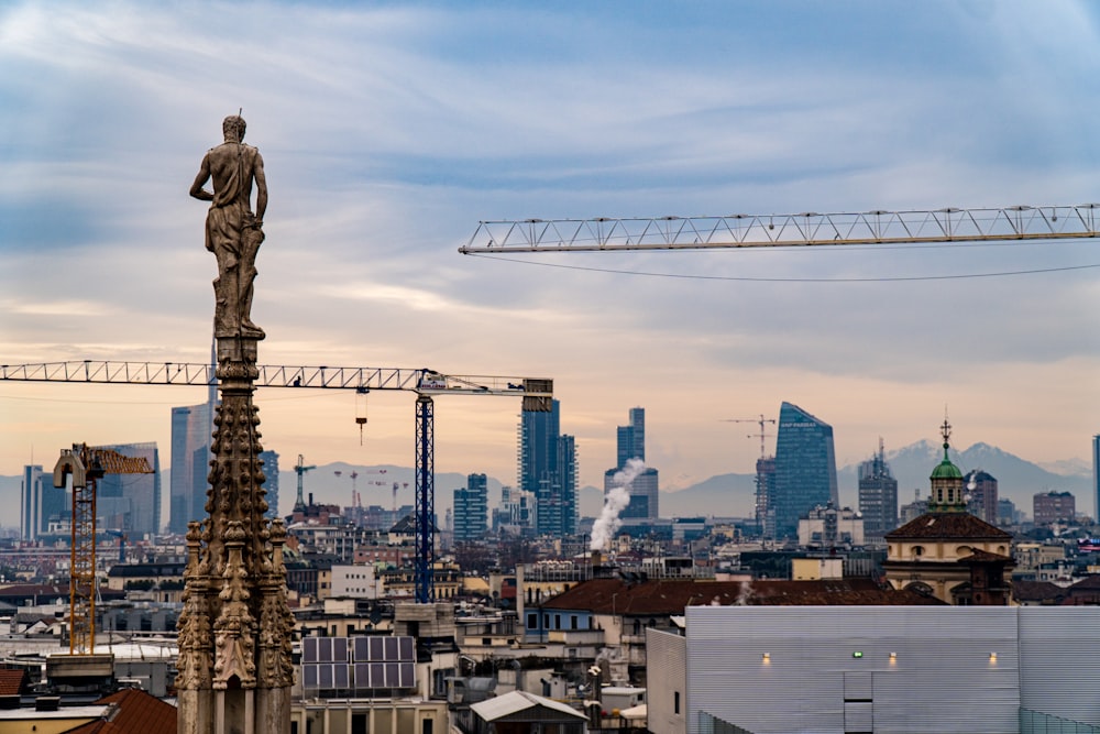 a statue of a man standing on top of a building