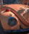 Close-up of a vintage Volkswagen Beetle engine being repaired by a skilled mechanic.