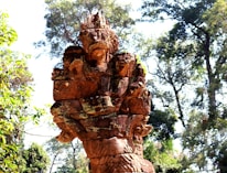 A close-up of an old Fijian artifact surrounded by lush jungle foliage.