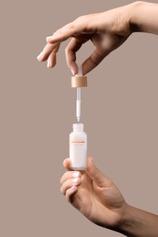 Close-up of hands preparing medication with care and precision.