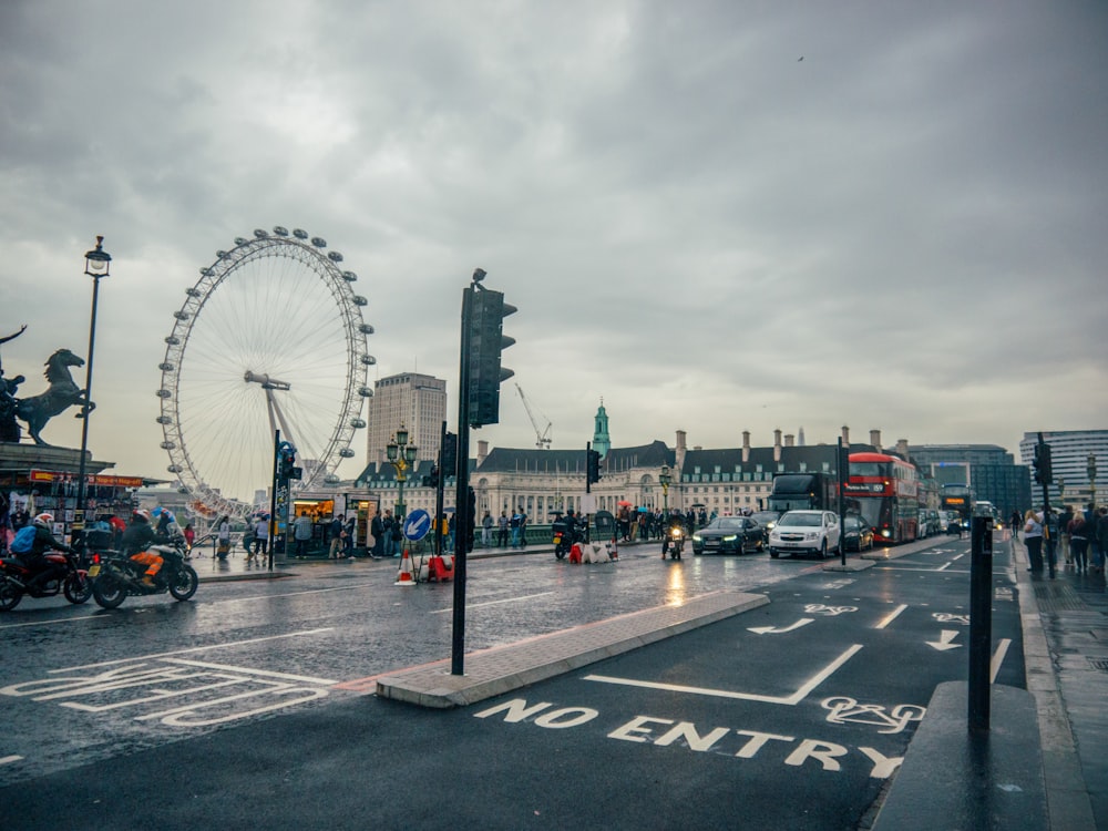 people walking on pedestrian lane near ferris wheel during daytime