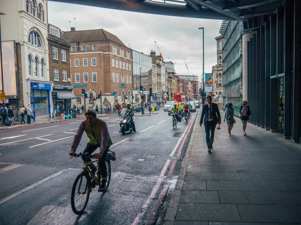 man in black shirt riding bicycle on road during daytime