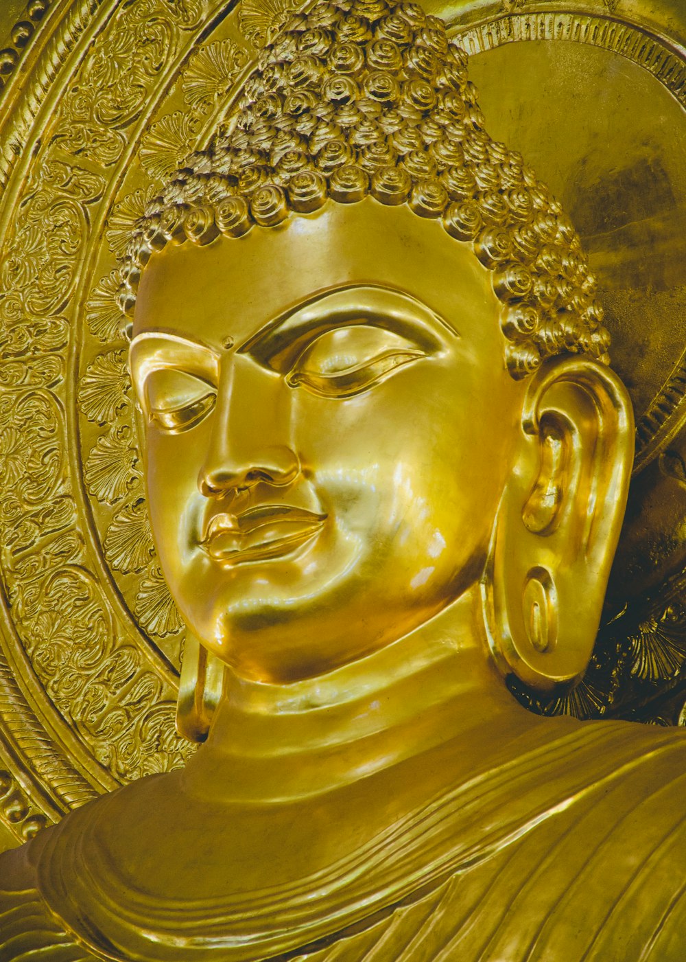 gold buddha statue in close up photography