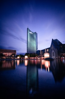 body of water near building during night time