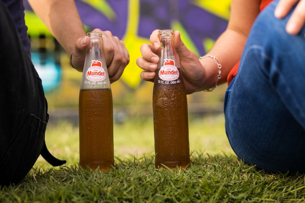 2 coca cola bottles on green grass