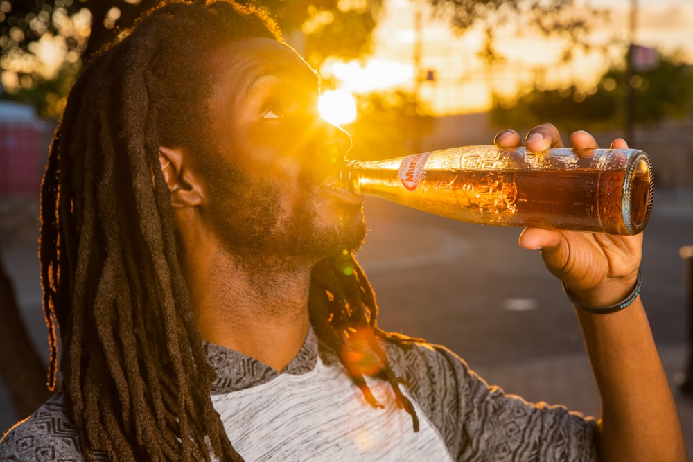 man drinking beer from bottle