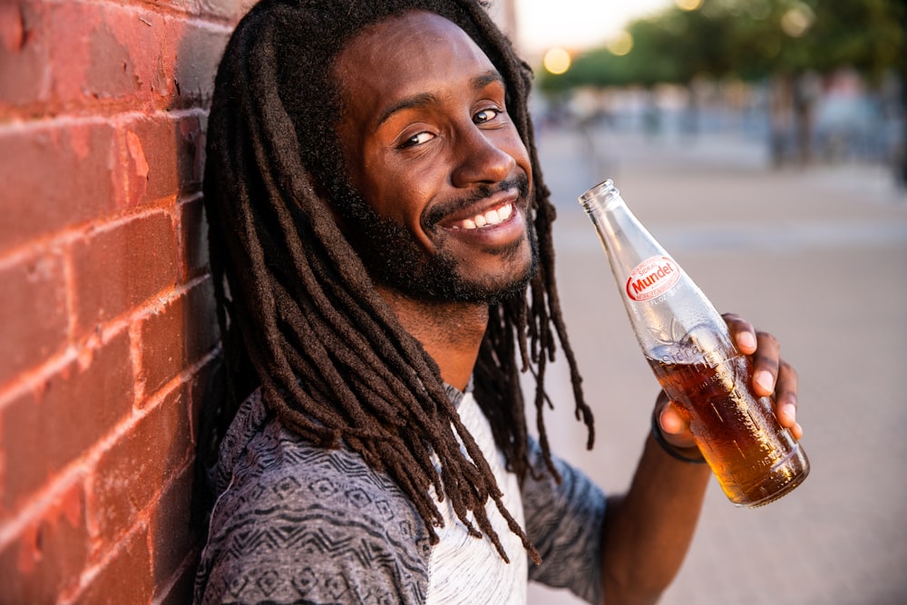 smiling woman holding coca cola bottle